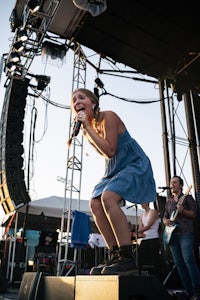 a woman singing on stage